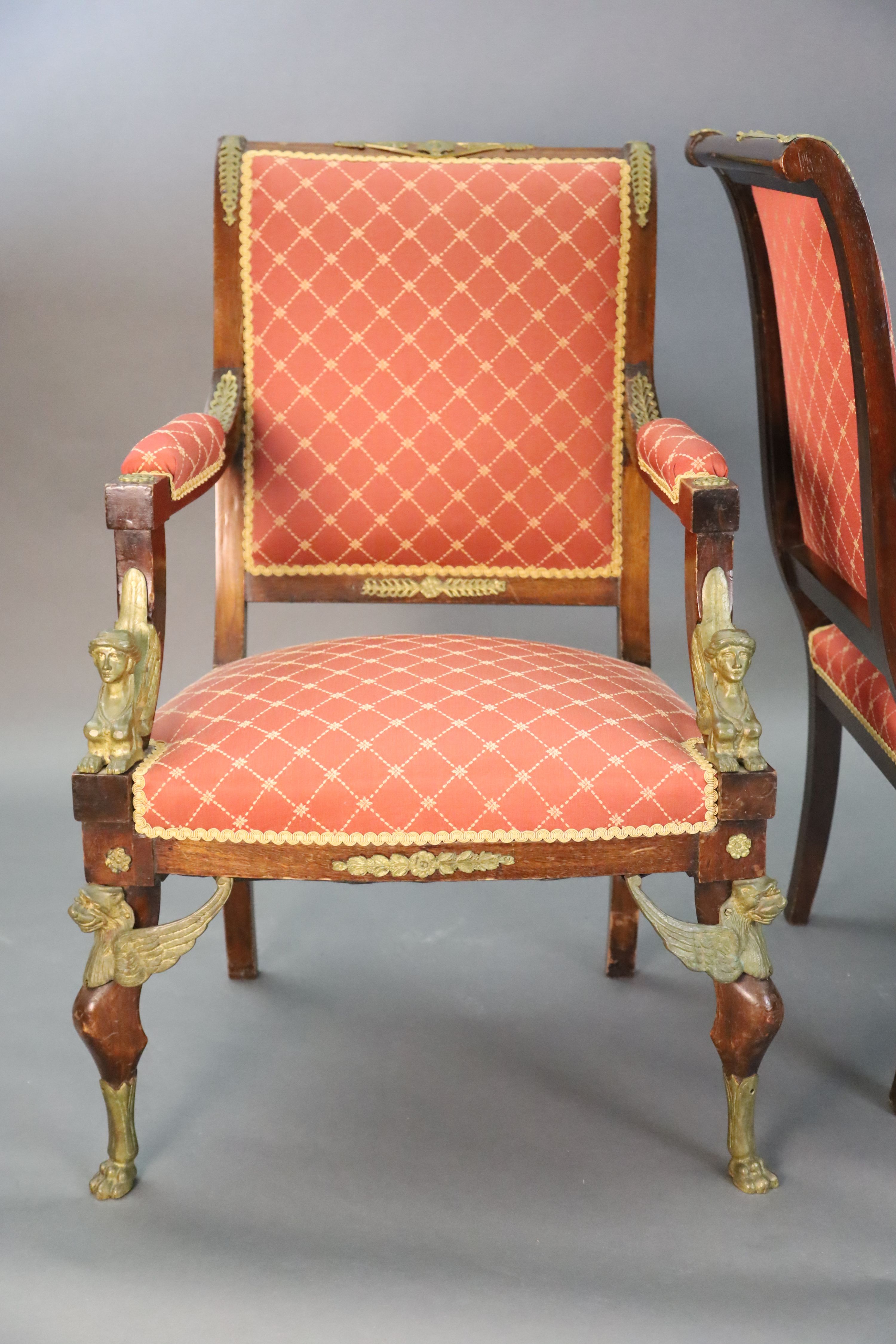 A late 19th century French Empire style ormolu mounted mahogany three piece salon suite, settee W.4ft 7in. D.2ft 5in. H.3ft 6in.